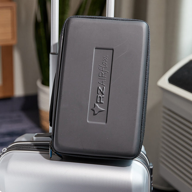 rz airflow carrying case sitting on top of a suitcase ready for travel