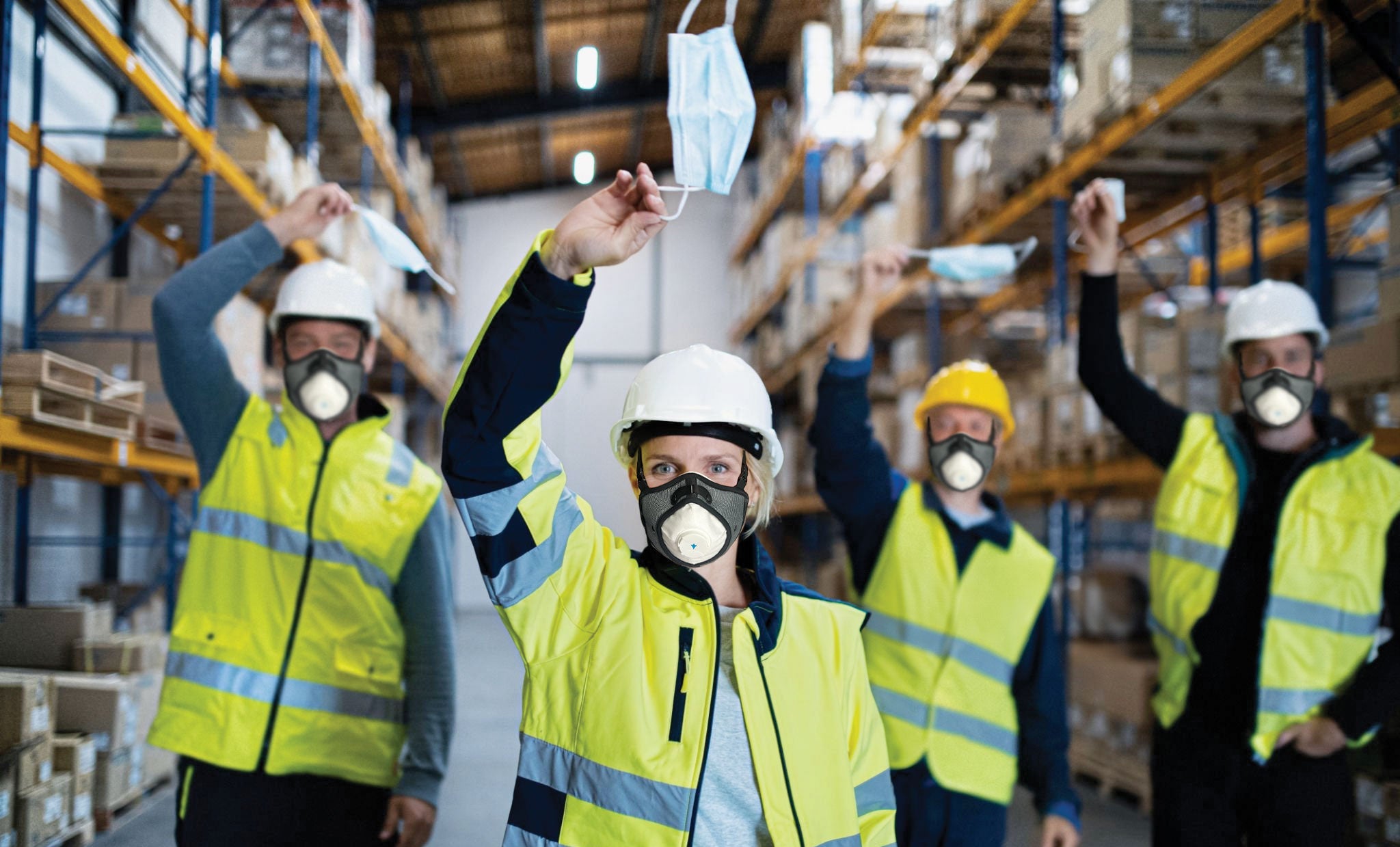 Group of workers in a warehouse wearing safety gear and RZ Pro FFP3 Masks.