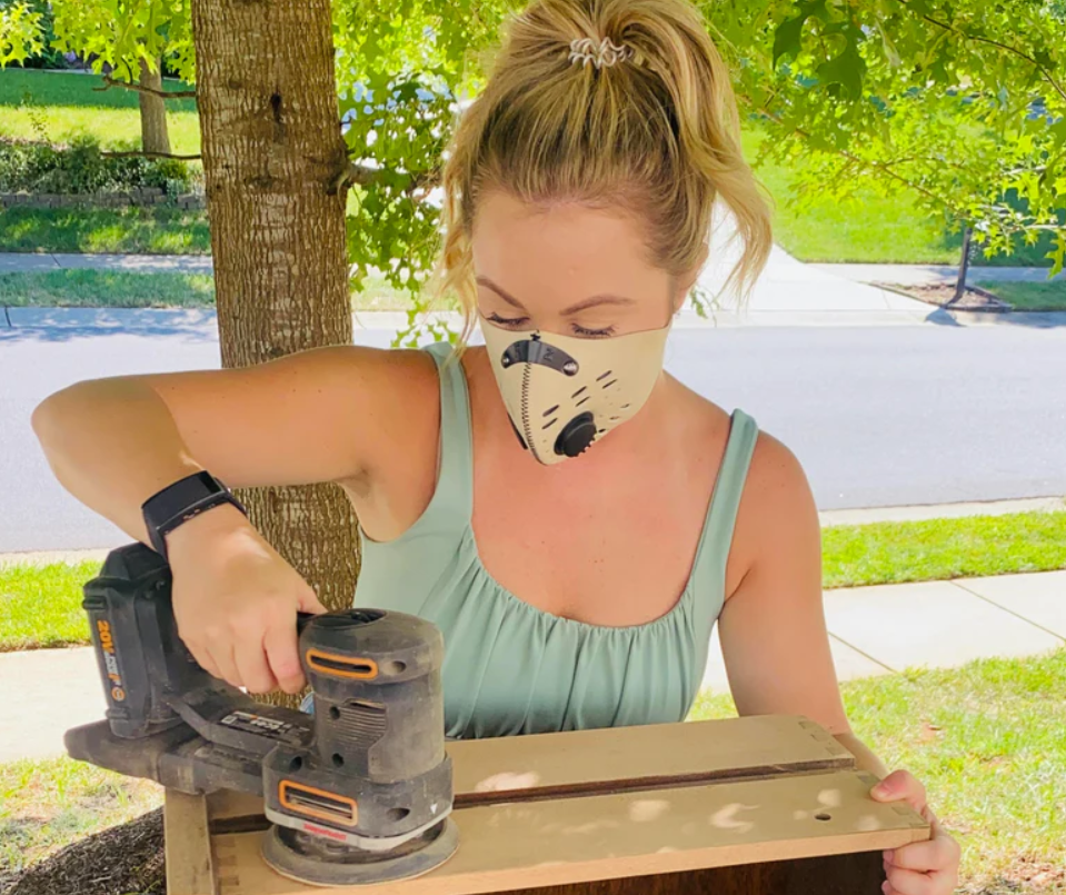 Woman woodworking while wearing M1 Neoprene RZ Mask