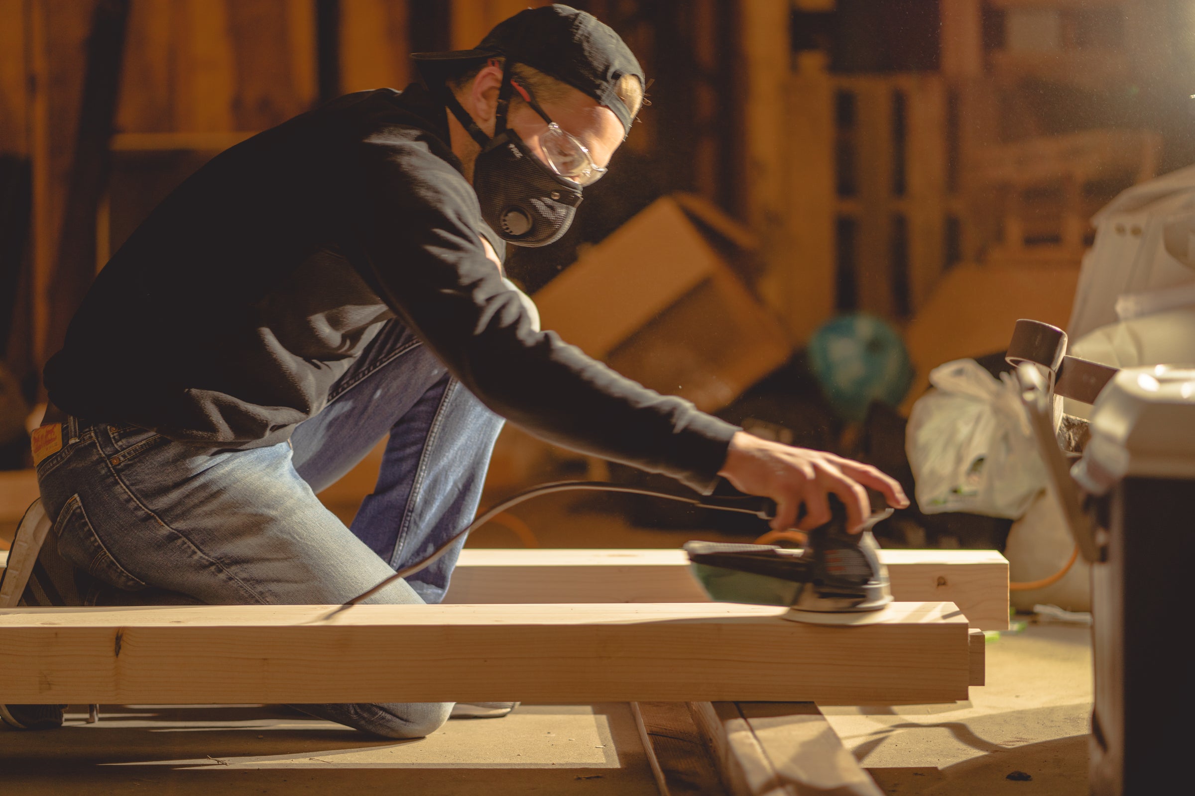 Woodworker using sander while wearing Black M2.5 Mask