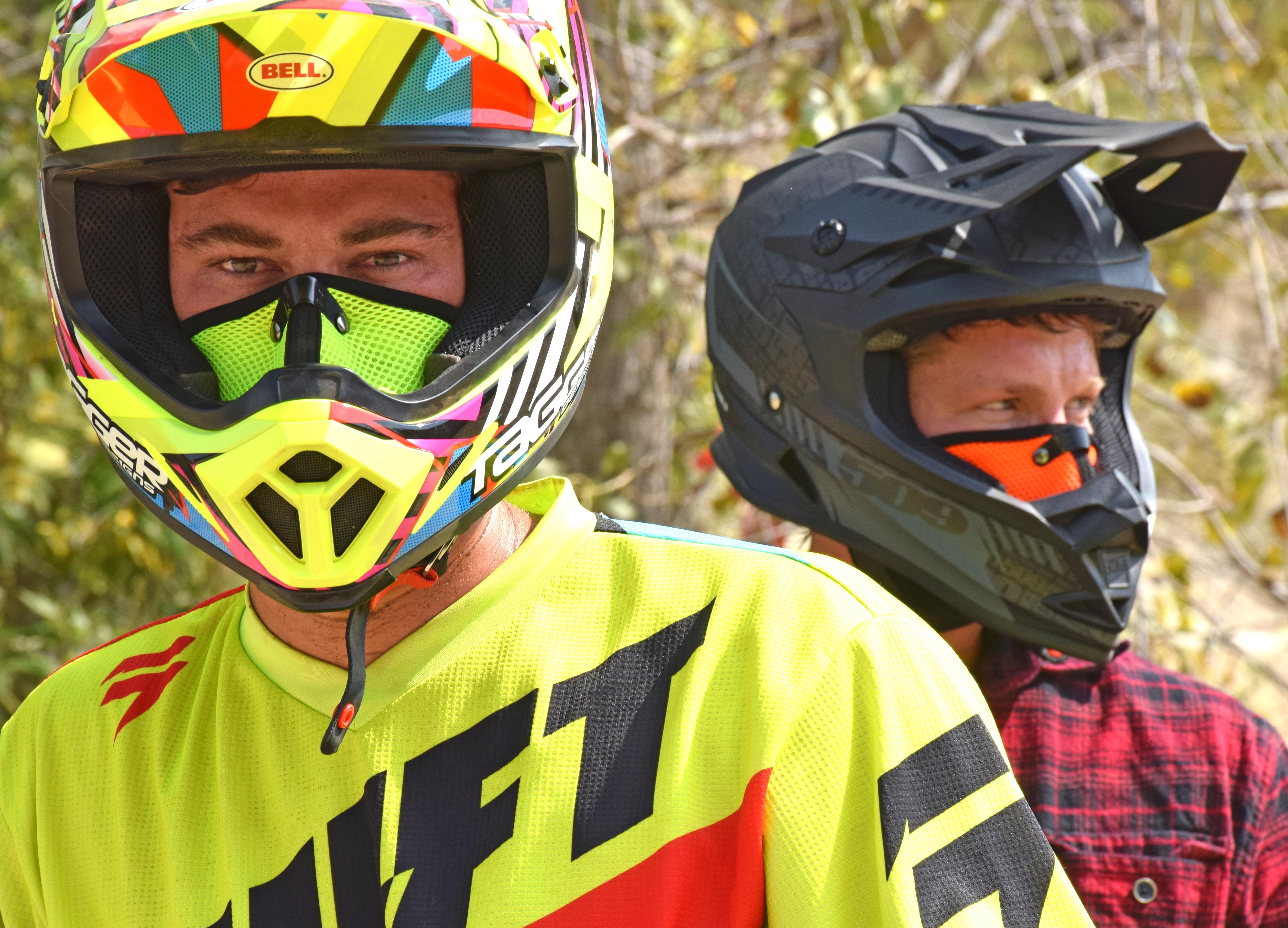 Two men wearing RZ Masks while preparing to go dirt biking while wearing helmets and rz masks to protect from dust