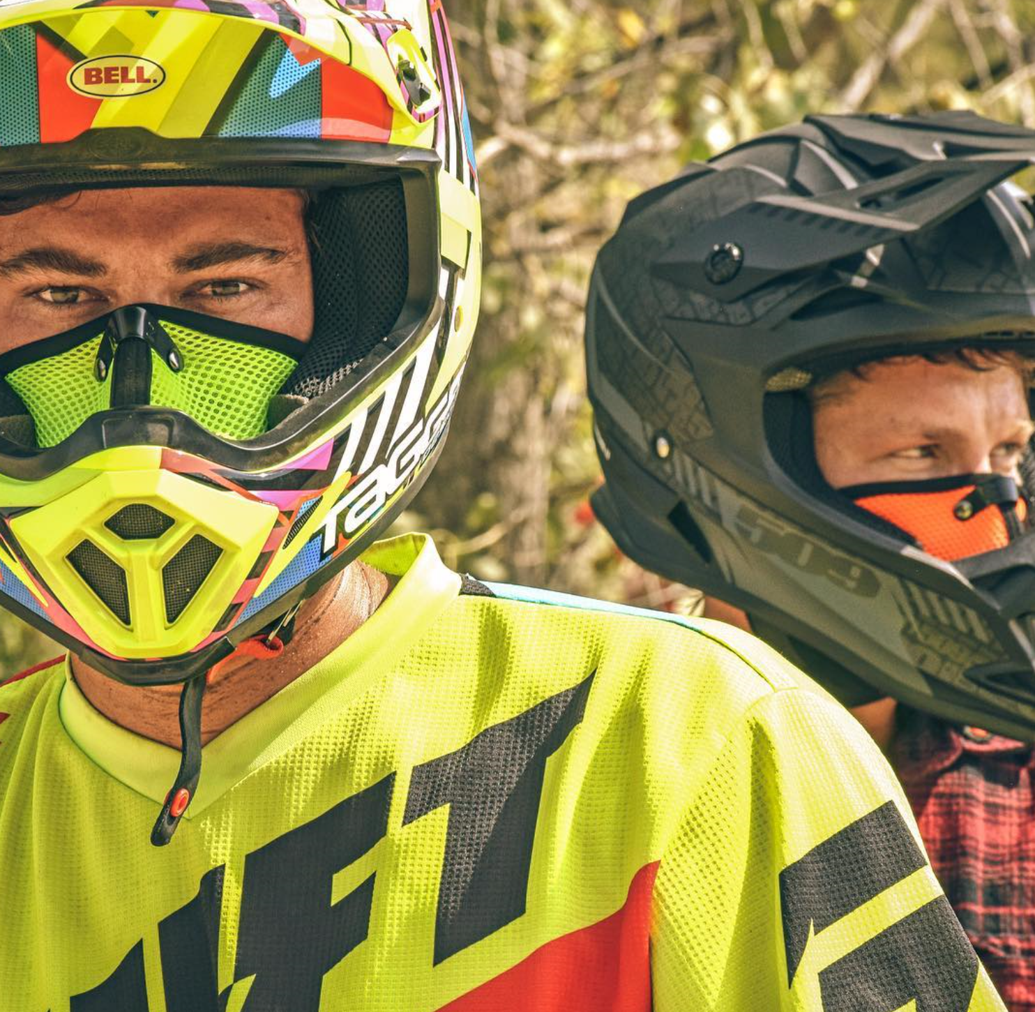 Two men wearing RZ Masks while preparing to go dirt biking while wearing helmets and rz masks to protect from dust