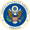 Seal of the United States with 'Embassy' text on a blue background