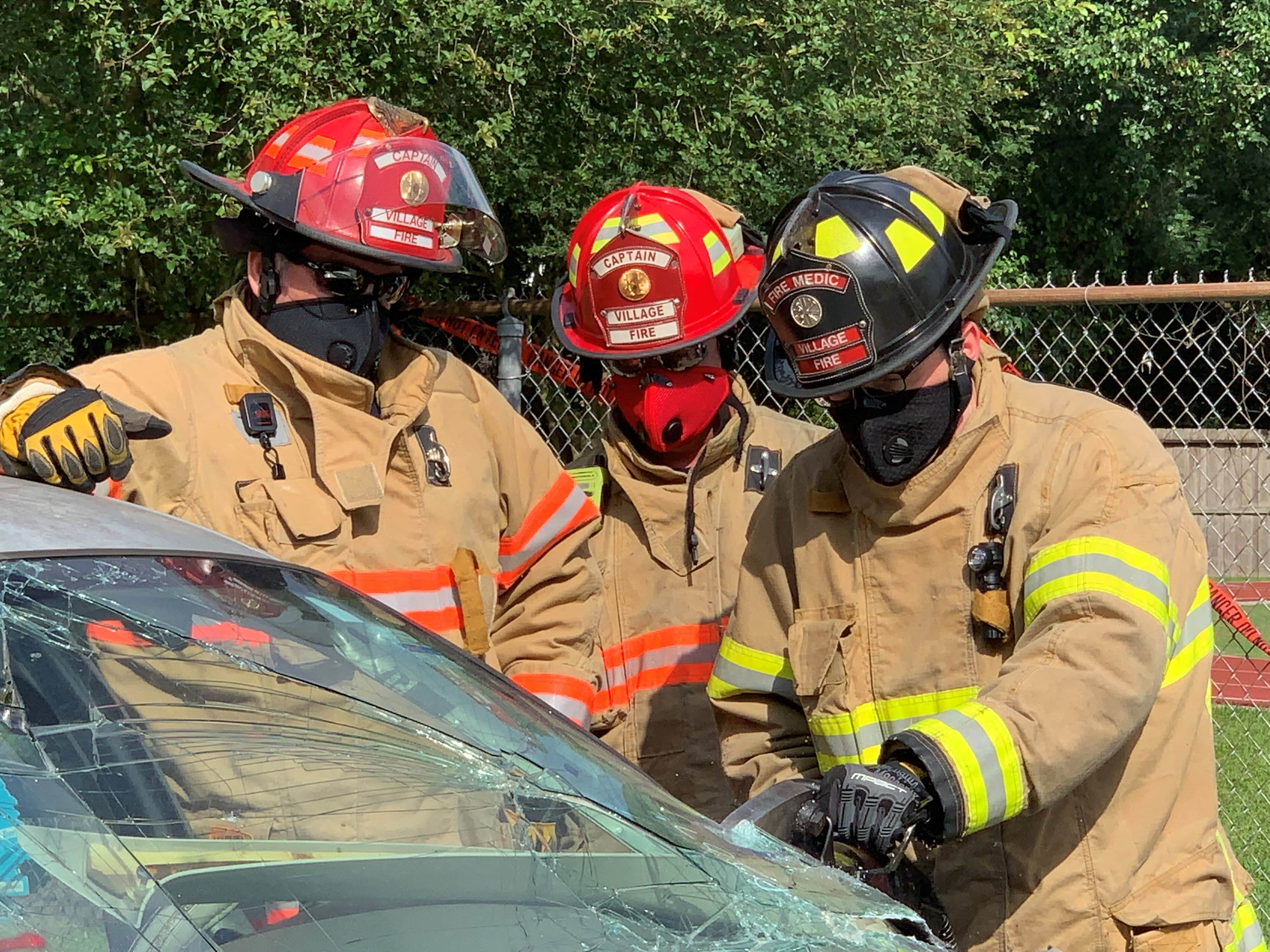 Village Fire Department members wearing the RZ Mask for protection from dust and particulates while practicing car accident rescue.