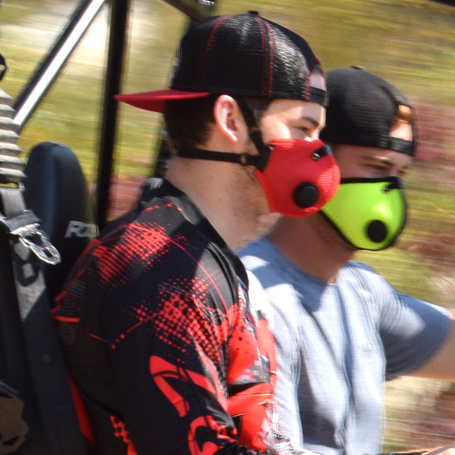 two men wearing rz mask M2.5 masks to protect from dust while riding in their UTV.