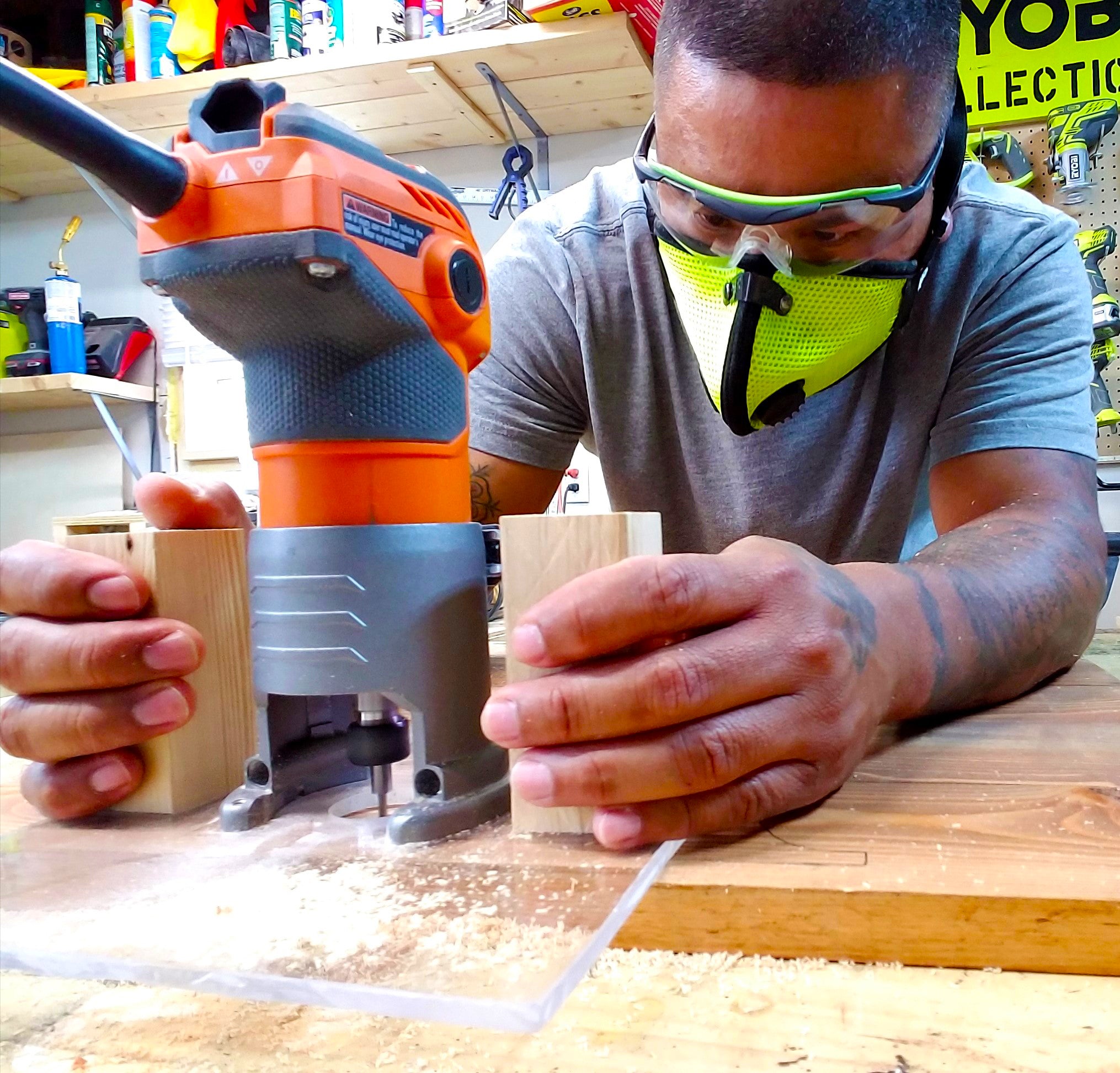 man wearing rz mask m2 safety yellow while using a router in a woodshop to protect against saw dust