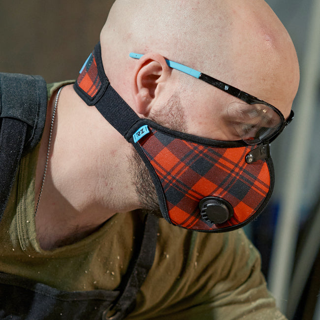 Man wearing and RZ Mask M2N Red Plaid while woodworking