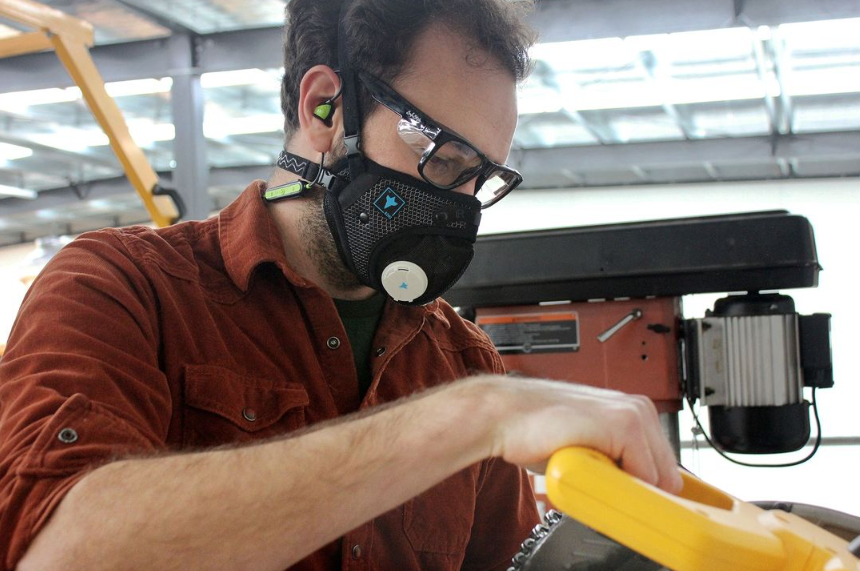 Woodworker using a table saw while wearing the RZ M3 Mask