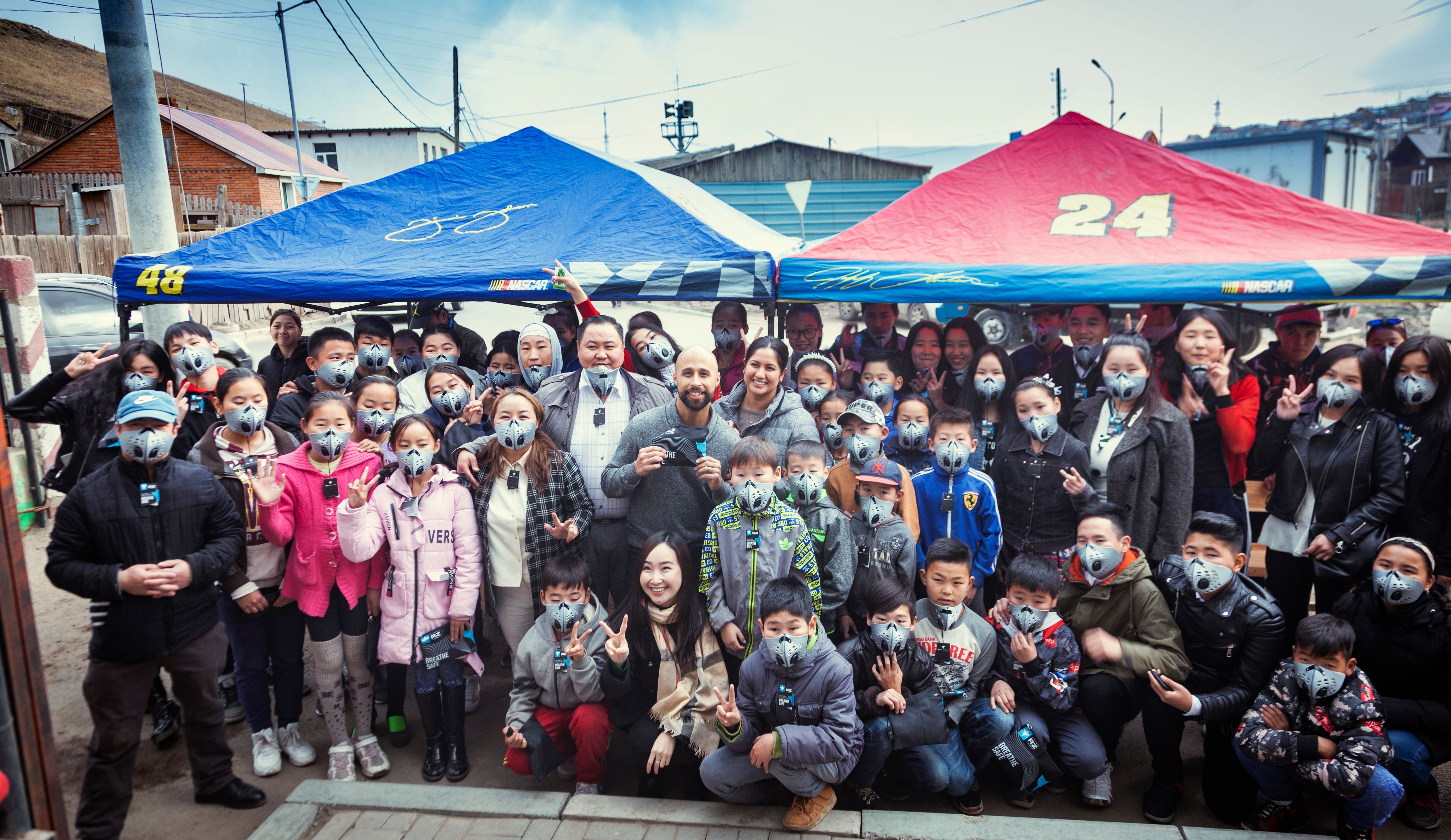 A large group of people in Mongolia all wearing rz masks wearing rz masks to protect against pollution. The masks were donated by rz industries/rz mask