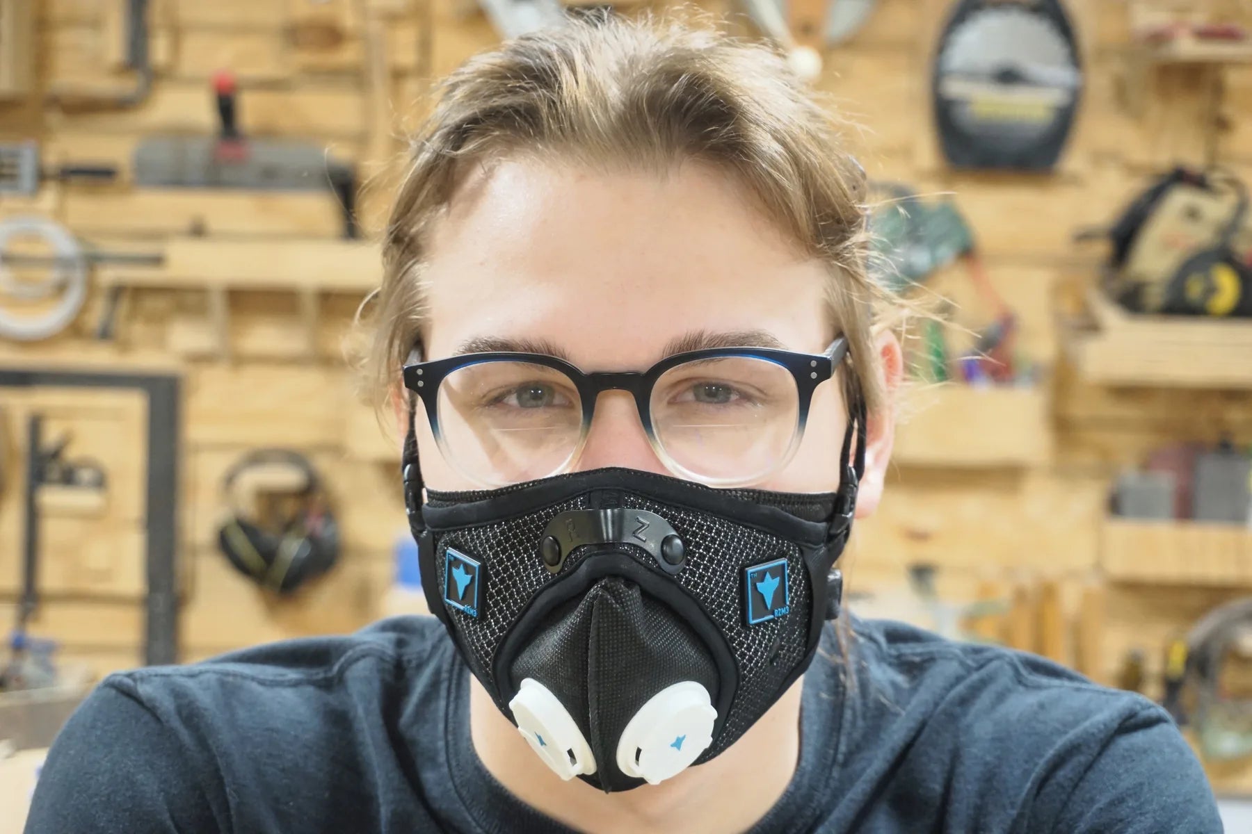 A maker wearing an RZ mask and safety glasses in a workshop